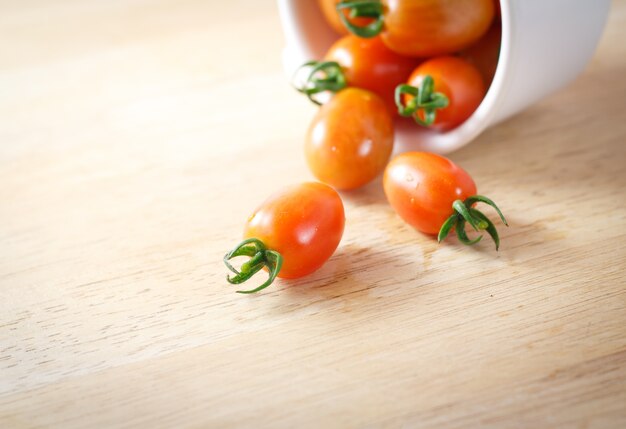 Close-up of fresh, ripe cherry tomatoes on wood