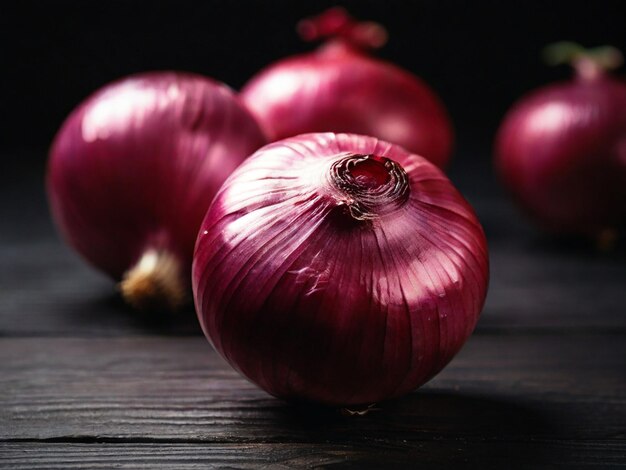 Close up of fresh ripe red onion on wooden table on black background