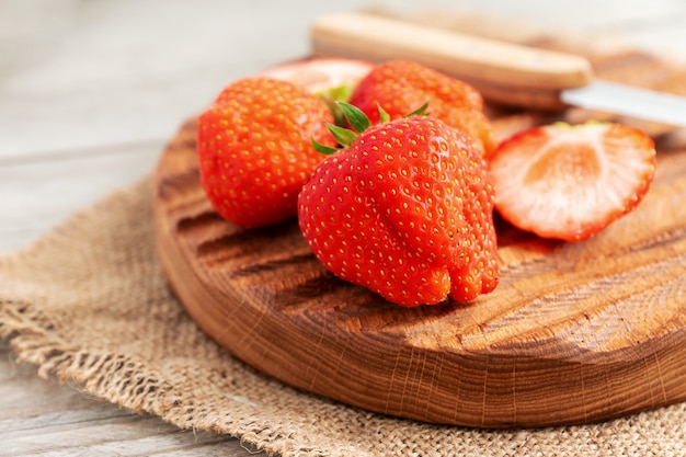 Close up of fresh ripe strawberry on cutting board