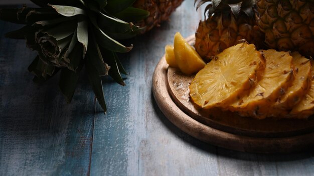 Close up fresh sliced pineapple on wooden background Top view tropical fruits summer concept