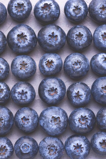 Photo close up of fresh and tasty blueberries on backgroundtop view toned