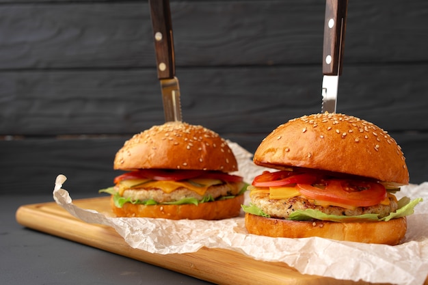 Close up of fresh tasty burger against black background