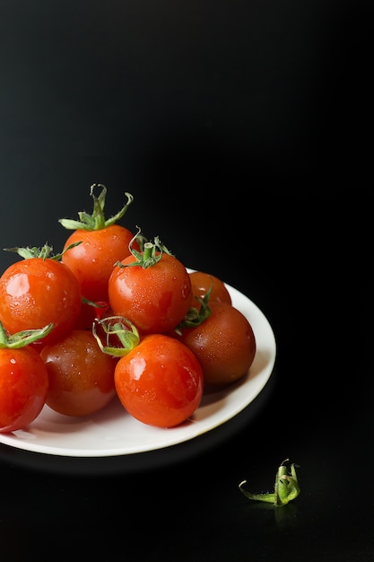 close up fresh tomato on black table  background.