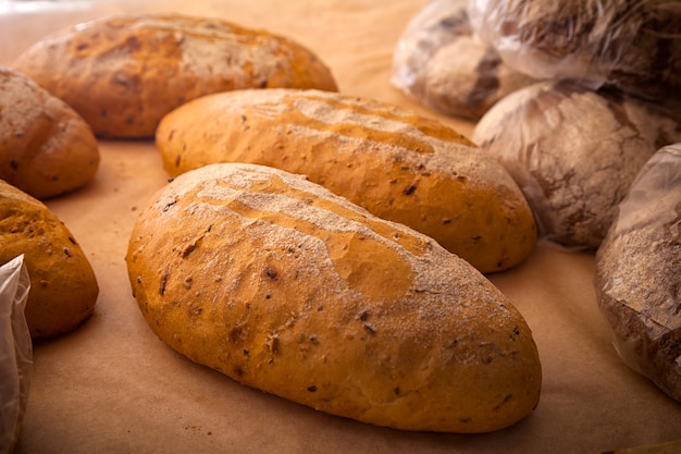 Close-up of fresh white bread in buns in a bakery, fresh loaves