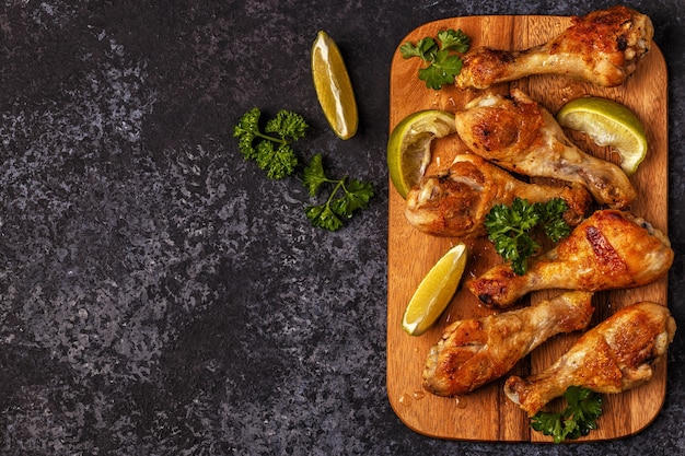 Close up on fried chicken legs on cutting board