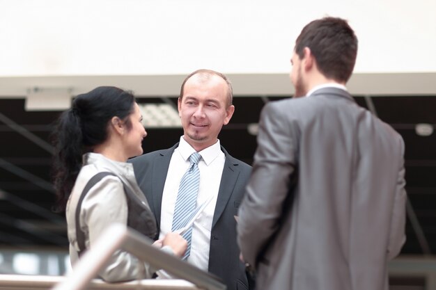 Close up. friendly colleagues talking in the office.photo with copy space