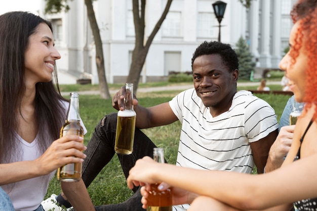 Close up friends holding bottles