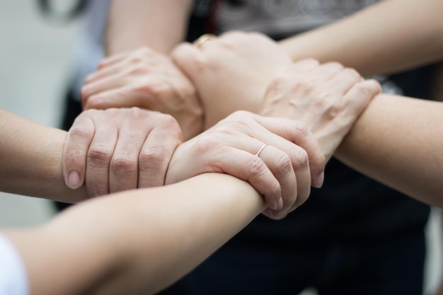 Close-up of friends holding hands