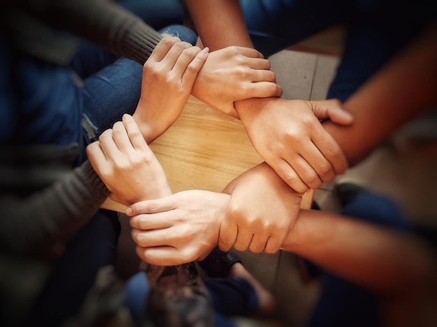 Close-up of friends holding hands