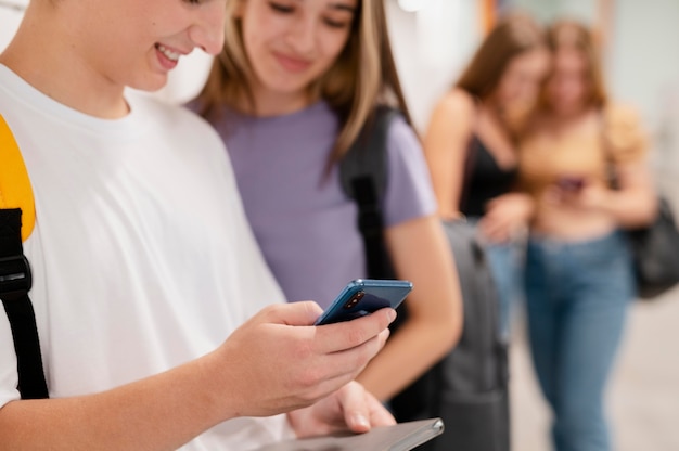 Close up friends with phones indoors