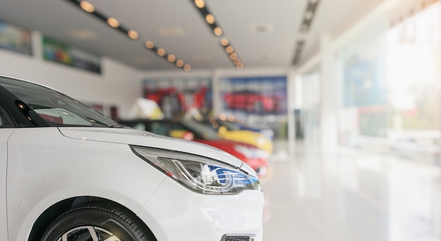 Close up front of new car in showroom background