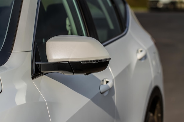 Close up front view of car side mirror. front rear view mirror
on the car window. car exterior details. white car mirror.