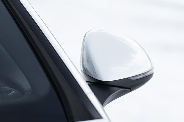 Close up front view of car side mirror Front rear view mirror on the car window White car exterior details