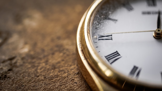 Close up front view of a modern wrist watch on the table. Soft focus. Free space for text