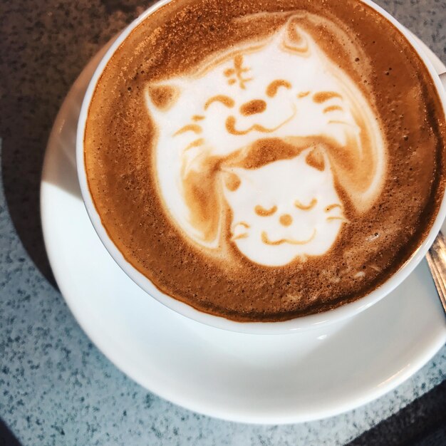 Close-up of froth art in cappuccino on table