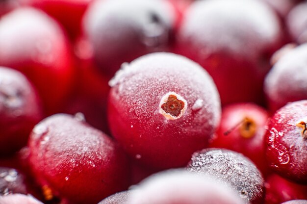 Close up frozen cranberries in a wooden bowl  Selective focus  
