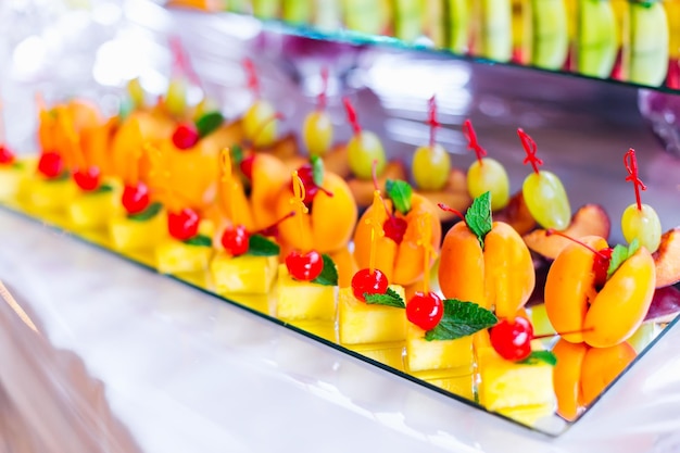 Close up fruit slicing on a transparent stand wedding banquet