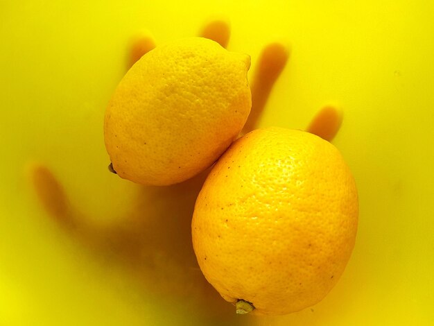 Close-up of fruit over yellow background