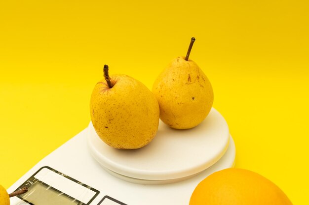 Close-up of fruits against yellow background