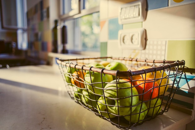 Close-up of fruits in basket on table at home