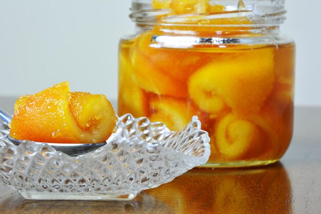 Close-up of fruits in glass jar on table