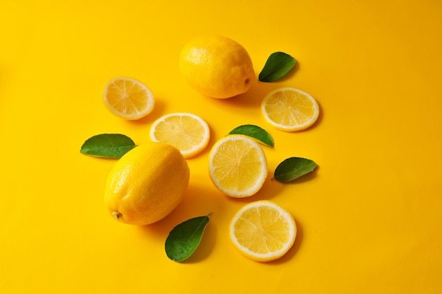 Close-up of fruits in glass over yellow background