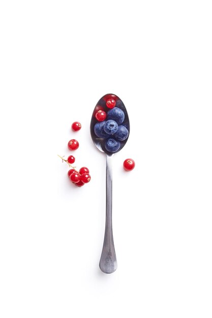 Photo close-up of fruits and spoon on white background