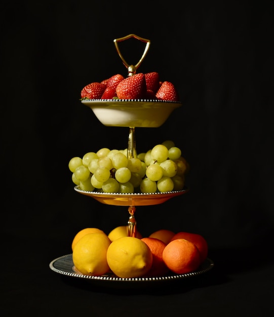 Photo close-up of fruits on table against black background