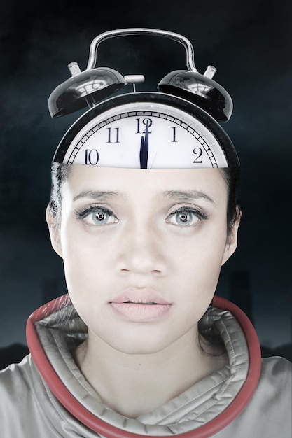 Close up of futuristic woman with alarm clock head