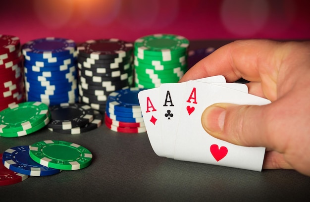 Photo close up of gambler hand takes playing cards in poker club