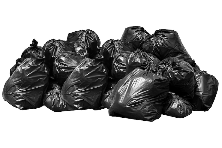Photo close-up of garbage bags against white background