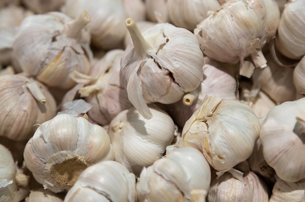 Close-up of garlic bulbs on grocery store shelf