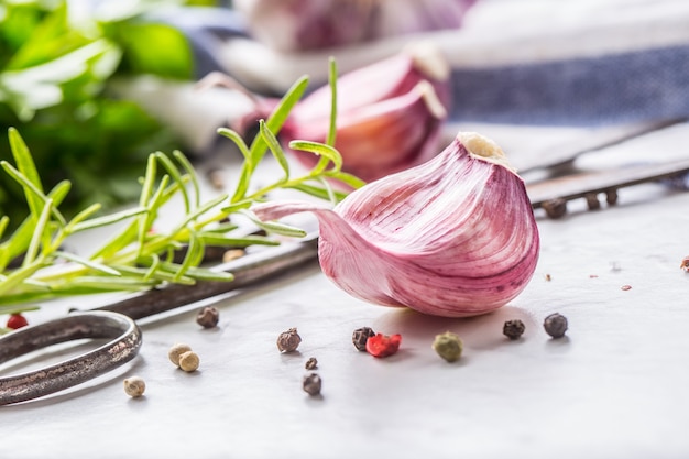 Close-up Garlic Cloves and Bulbs with rosemary salt and pepper.