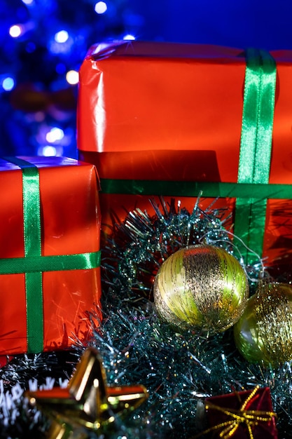 close up of gift boxes near decorated christmas tree