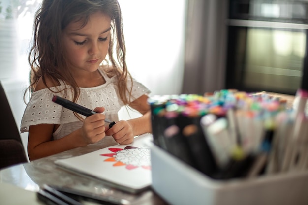 Photo close-up of girl drawing while sitting at home