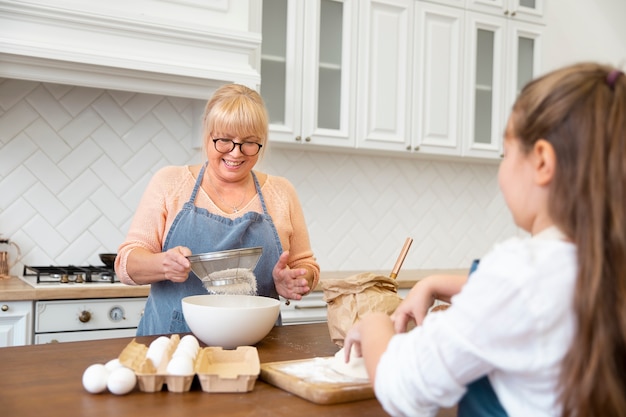 Close up girl and grandma cooking