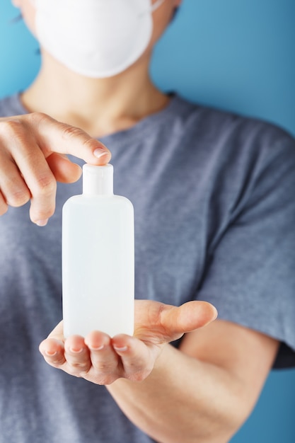 Close-up of a girl holding a Disinfectant gel in her hands. Antiseptic treatment of hands from bacteria Sanitizer.