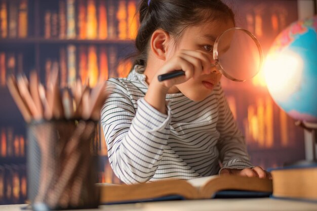 Close-up of girl holding magnifying glass