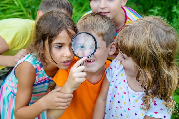Photo close-up of girl holding magnifying glass