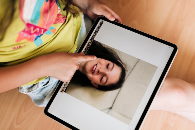 Close-up girl looking at photos on tablet