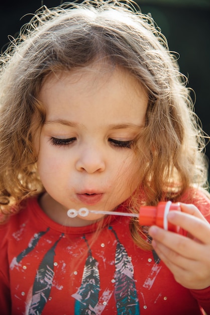 Photo close-up of girl playing girl playing with bubble wand