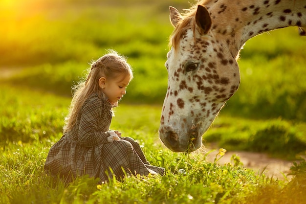 Close-up of girl sitting on field