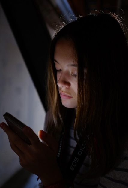 Close-up of girl using mobile phone