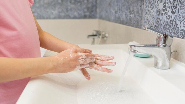 Close-up girl washing hands