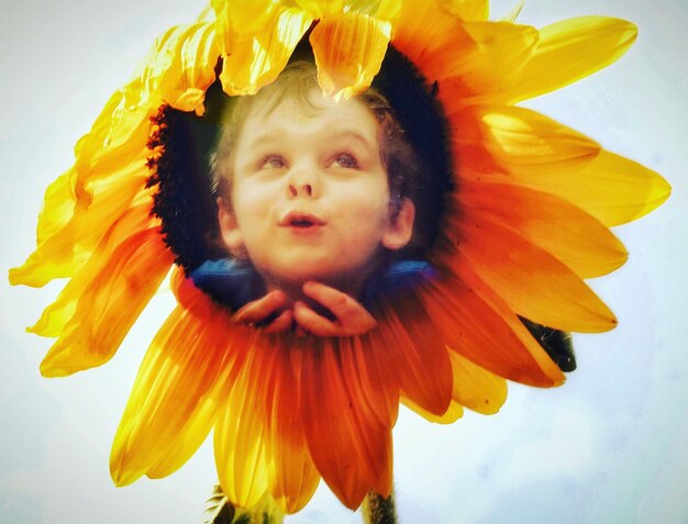 Close-up of girl with yellow flower