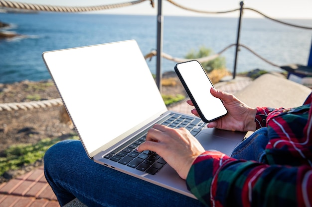 Close up of girl39s hands using computer and smartphone screens mockup