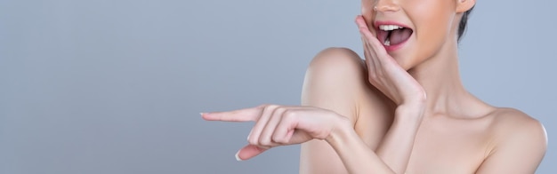 Close-up glamoureuze vrouw wijzende vinger reclame huidverzorgingsproduct