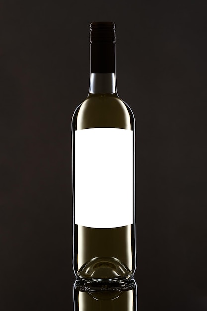 Photo close-up of glass bottle against black background