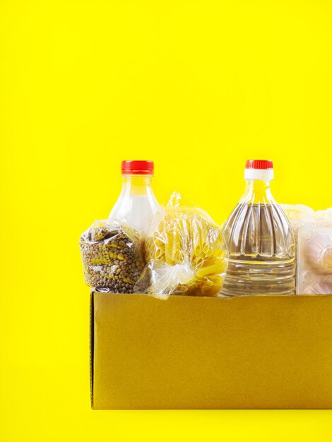 Close-up of glass bottle on table against yellow background