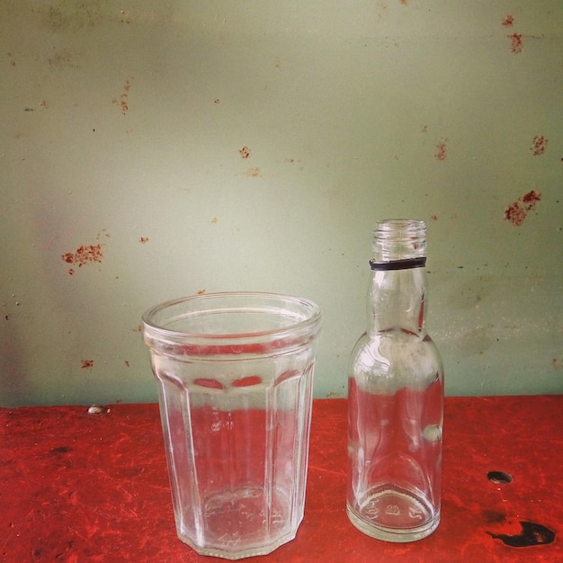 Close-up of glass and bottle on table